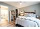 Comfortable bedroom with an ensuite bathroom, open closet, and a large bed with decorative pillows at 1111 Parkridge Ln # 103, Raleigh, NC 27605