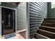Condo entrance with wood stairs, neutral siding and a welcoming door at 1111 Parkridge Ln # 103, Raleigh, NC 27605