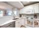Kitchen showcasing stainless steel dishwasher, modern appliances, and a pass-through to the living area at 1111 Parkridge Ln # 103, Raleigh, NC 27605