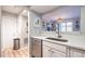 Kitchen showing stainless steel dishwasher, white countertops, and an open layout to living area at 1111 Parkridge Ln # 103, Raleigh, NC 27605