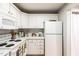 Well-lit kitchen features white appliances, matching cabinetry, and a contrasting countertop at 1111 Parkridge Ln # 103, Raleigh, NC 27605