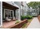 Outdoor patio with seating area, privacy wall, and a view of the complex grounds at 1111 Parkridge Ln # 103, Raleigh, NC 27605