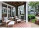 Relaxing outdoor patio featuring wicker furniture, patterned rug, and views of the surrounding landscape at 1111 Parkridge Ln # 103, Raleigh, NC 27605