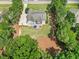 Expansive lot with mature trees, outdoor patio with furniture, and long driveway at 113 Cedardale Ct, Clayton, NC 27520