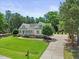 Expansive property showcasing a well-manicured lawn, elongated driveway, and beautiful landscaping at 113 Cedardale Ct, Clayton, NC 27520