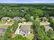 Aerial view of a home surrounded by lush greenery and mature trees in a quiet neighborhood at 113 Cedardale Ct, Clayton, NC 27520
