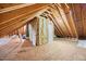 Unfinished attic with exposed rafters and insulation, showing potential for expansion at 113 Cedardale Ct, Clayton, NC 27520