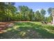 Large backyard features a manicured lawn and patio area for outdoor entertaining at 113 Cedardale Ct, Clayton, NC 27520
