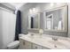 Bathroom features a double vanity, framed mirrors and a shower with a blue curtain at 113 Cedardale Ct, Clayton, NC 27520