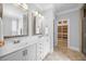 Bright bathroom features double sink vanity with marble countertop, framed mirrors and access to a custom closet at 113 Cedardale Ct, Clayton, NC 27520