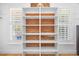 Custom closet boasts built-in shelving with shudders providing natural light at 113 Cedardale Ct, Clayton, NC 27520