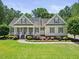 Charming home featuring a landscaped front yard, cozy porch, and neutral siding, exuding curb appeal at 113 Cedardale Ct, Clayton, NC 27520