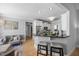 Bright kitchen with stainless appliances, breakfast bar, hardwood floors and seamless access to seating and stairs at 113 Cedardale Ct, Clayton, NC 27520