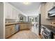 Bright kitchen featuring stainless steel appliances, neutral cabinets, granite counters, and hardwood floors at 113 Cedardale Ct, Clayton, NC 27520