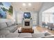 Relaxing living room featuring a fireplace, TV, hardwood floors and comfortable seating arrangements at 113 Cedardale Ct, Clayton, NC 27520