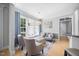 Cozy sitting room featuring hardwood floors, large windows with curtains, and plush armchairs at 113 Cedardale Ct, Clayton, NC 27520