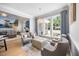 Bright living room featuring hardwood floors, large windows, comfortable seating, and ceiling fan at 113 Cedardale Ct, Clayton, NC 27520