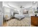 Spacious main bedroom featuring tray ceiling, ceiling fan, natural light, and hardwood floors at 113 Cedardale Ct, Clayton, NC 27520