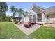 Relaxing patio area with lounge chairs and outdoor dining near a screened porch at 113 Cedardale Ct, Clayton, NC 27520