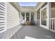 Cozy back porch area with two chairs and an entry door at 113 Cedardale Ct, Clayton, NC 27520