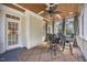 Screened-in porch has a wood ceiling, curtains and comfortable seating for outdoor living at 113 Cedardale Ct, Clayton, NC 27520