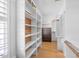 This walk-in closet features built-in shelving, a dresser, and a mirror for added convenience at 113 Cedardale Ct, Clayton, NC 27520