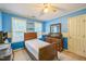 Bright bedroom featuring blue walls, a single bed, and natural light from the windows at 115 Redbay Ln, Clayton, NC 27527