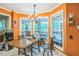 Bright breakfast nook featuring large windows, a chandelier and wood dining table at 115 Redbay Ln, Clayton, NC 27527