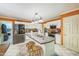 Functional kitchen with white cabinetry, central island with sink and seating, plus stainless steel appliances at 115 Redbay Ln, Clayton, NC 27527