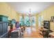 Open living room with hardwood floors, natural light, and chandelier at 115 Redbay Ln, Clayton, NC 27527