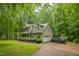 Lovely home showcasing a paved driveway, attached garage, and verdant lawn at 115 Redbay Ln, Clayton, NC 27527
