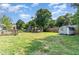 Expansive backyard featuring a shed, dog run, and mature trees at 118 Lynn Rd, Durham, NC 27703