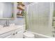 Bathroom with a shower-tub combo, white tile and a vanity at 118 Lynn Rd, Durham, NC 27703