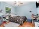 Bright bedroom with a wooden floor and ceiling fan at 118 Lynn Rd, Durham, NC 27703