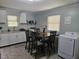Bright dining area combined with laundry features a table for four and natural light perfect for mealtime and chores at 118 Lynn Rd, Durham, NC 27703