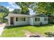 Charming single-story home featuring a classic white brick exterior and well-maintained lawn at 118 Lynn Rd, Durham, NC 27703