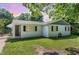 Charming single-story home featuring a classic white brick exterior and well-maintained lawn at 118 Lynn Rd, Durham, NC 27703