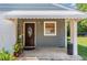 Cozy front porch with decorative plants, seating area, and a charming front door at 118 Lynn Rd, Durham, NC 27703