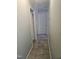 Clean hallway featuring tile flooring and neutral paint, providing access to various rooms within the home at 118 Lynn Rd, Durham, NC 27703