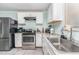 Well-lit kitchen features stainless steel appliances, granite countertops, and ample white cabinetry at 118 Lynn Rd, Durham, NC 27703