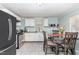 Bright kitchen boasts modern appliances, white cabinets, granite counters, and an adjacent dining area at 118 Lynn Rd, Durham, NC 27703