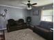 Comfortable living room with plush seating, ceiling fan, and neutral decor, creating a relaxing atmosphere at 118 Lynn Rd, Durham, NC 27703