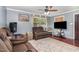 Spacious living room with plush seating, ceiling fan, and natural light from a large window at 118 Lynn Rd, Durham, NC 27703