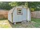 Storage shed with shingle roof, a window, and block foundation at 118 Lynn Rd, Durham, NC 27703