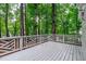 Back deck with unique modern railing overlooking a backyard forest at 1208 Mossy Glade Cir, Apex, NC 27502