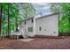 Rear exterior view of a two-story home featuring a deck and a patio at 1208 Mossy Glade Cir, Apex, NC 27502