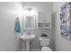 Bright bathroom featuring a pedestal sink, toilet, and medicine cabinet at 1208 Mossy Glade Cir, Apex, NC 27502