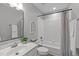 Bathroom featuring a tub with tile surround, a vanity and a mirror at 1208 Mossy Glade Cir, Apex, NC 27502