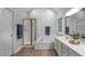 Bright bathroom featuring a tub-shower, stylish vanity, and modern fixtures at 1208 Mossy Glade Cir, Apex, NC 27502