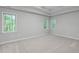 Primary bedroom featuring neutral colors, carpet flooring, and multiple windows at 1208 Mossy Glade Cir, Apex, NC 27502